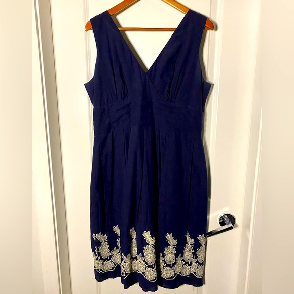 Navy blue V-neck, empire waist dress with floral-embroidered detail at bottom - Picture 1 of 5